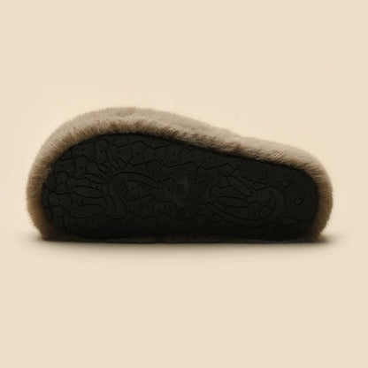 Grey plush slippers featuring a chunky bear with blue suspenders and a large polka-dot bow, cozy indoor shoes with rubber sole